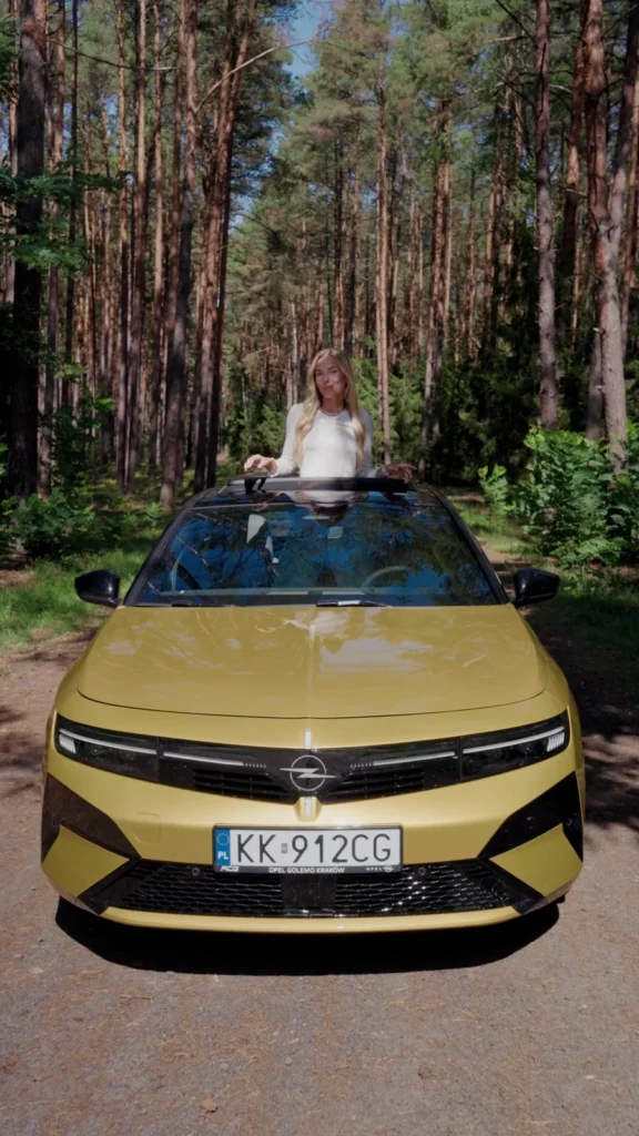 Woman beside an Opel car during an outdoor shoot
