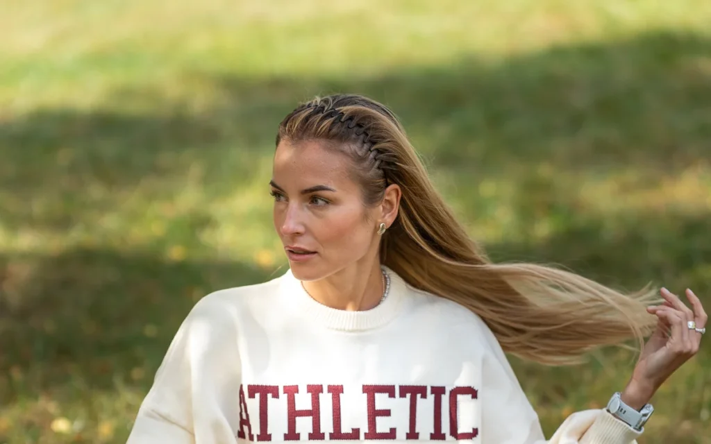 Creator wearing a cream Athletic sweatshirt during a fashion shoot for Zalando boards